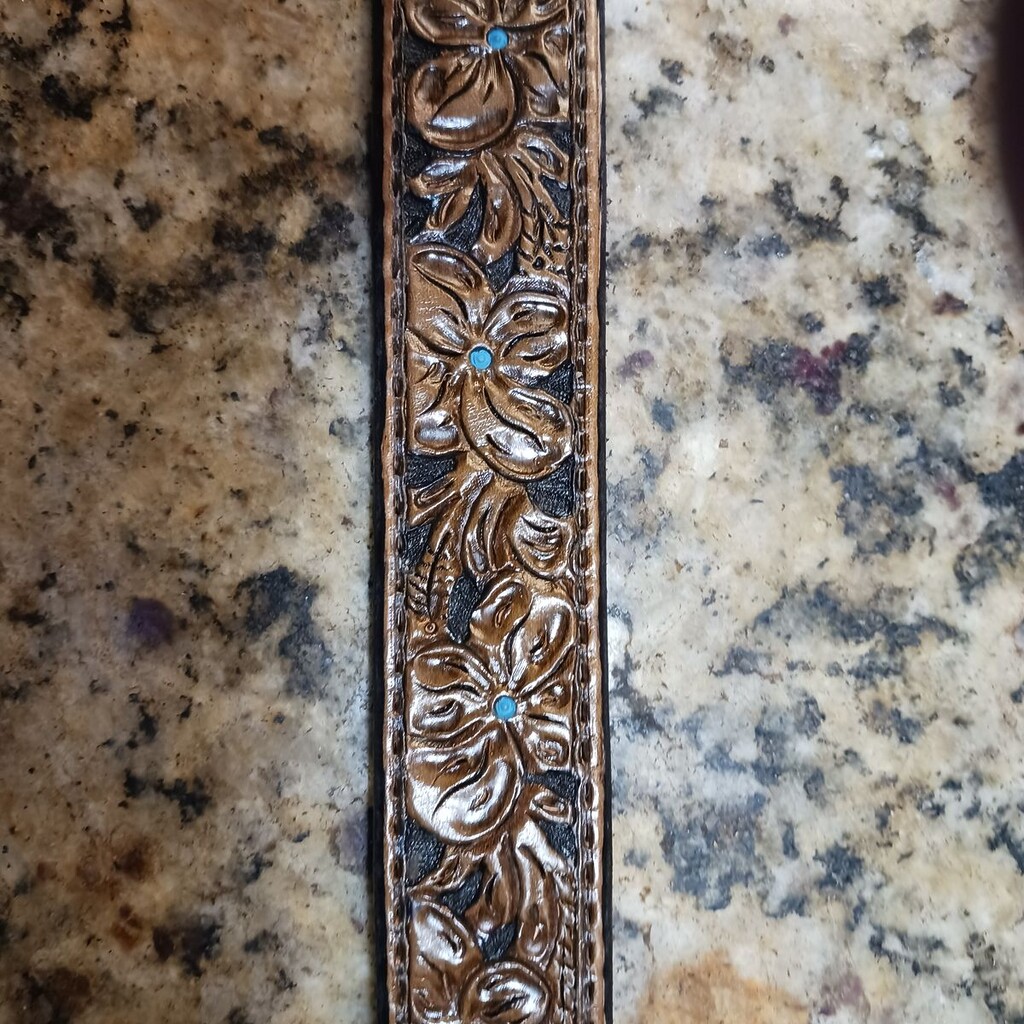 A carved belt made from a Hermann Oak belt blank.